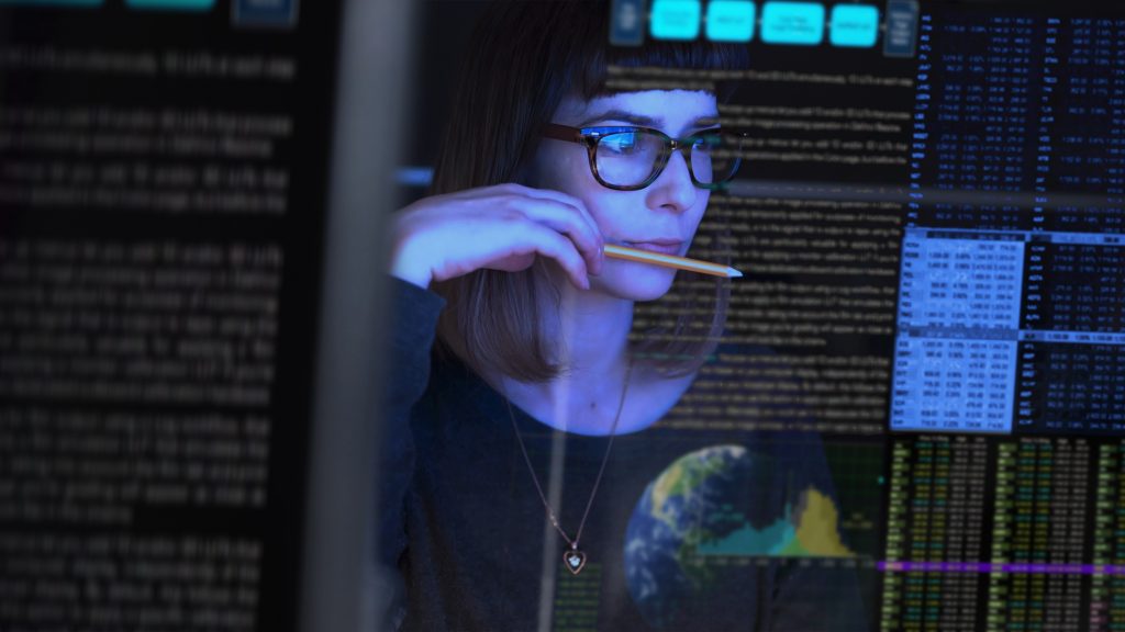 Young woman studying a see through computer screen